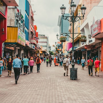 Pedestrians walking in a busy San Jose shopping district.
