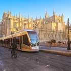 Tram in front of Cathedral of Seville, this is one of the most popular landmark in Seville, Spain; Shutterstock ID 1279438279; your: Claire Naylor; gl: 65050; netsuite: Online Ed; full: Getting around seville